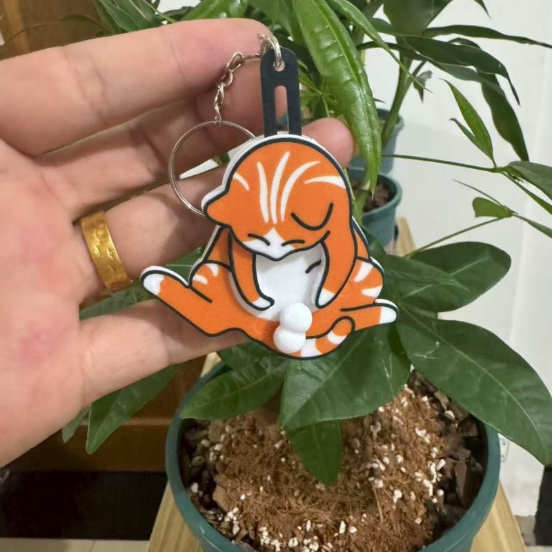 Playing with eggs and kitten keychain